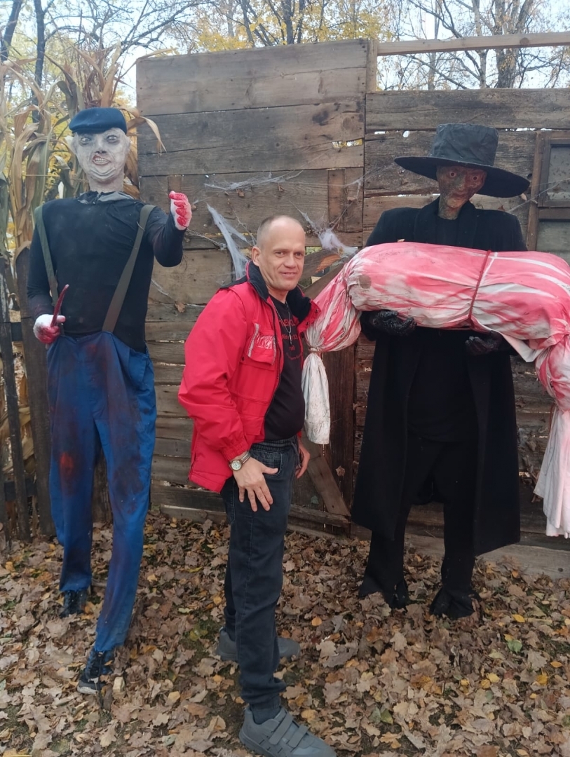 apmeklētāji ar šausmu parka dekorācijām